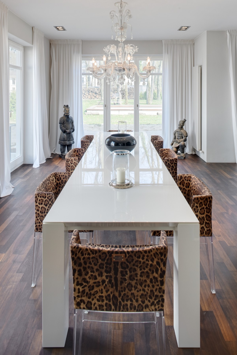 The Best Upholstery in BERLINRODEO's Interior Design living room with cheetah print dinning chairs and a white table