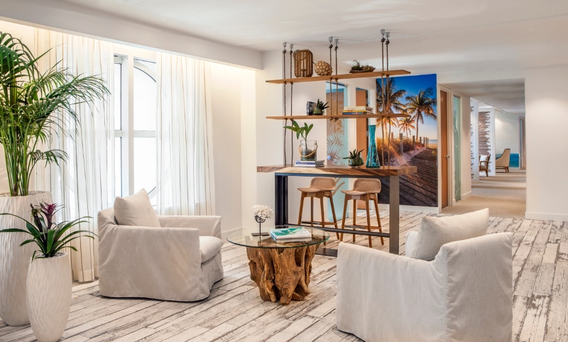 Employees and potential clients exit out of the bank building's black granite elevators onto a very different beachy environment within a few floors.