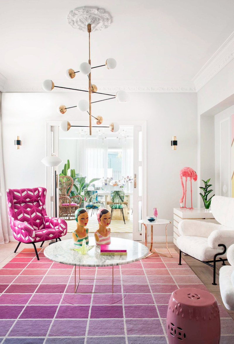 living room by Patricia Bustos Studio with pink tones rug, pink armchair, white armchairs and marble center table