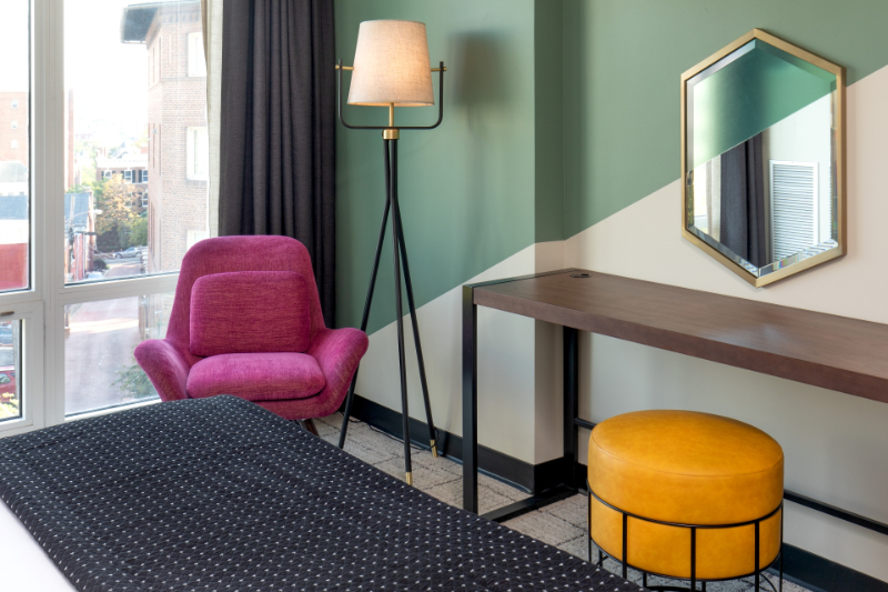 Studio 11 Design: Upholstered Furniture Inspiration. In this hotel room there is a pink upholstered arm chair and a yellow upholstered stool.